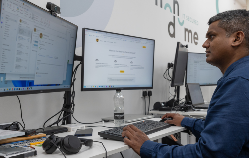 Photo of a member of the Iron Dome team at their workstation providing Managed IT support