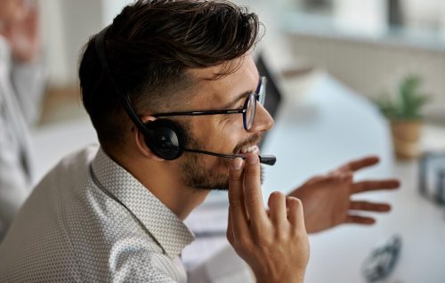 happy-call-center-agent-wearing-headset-while-talking-with-clients-working-office_637285-6173 (1)